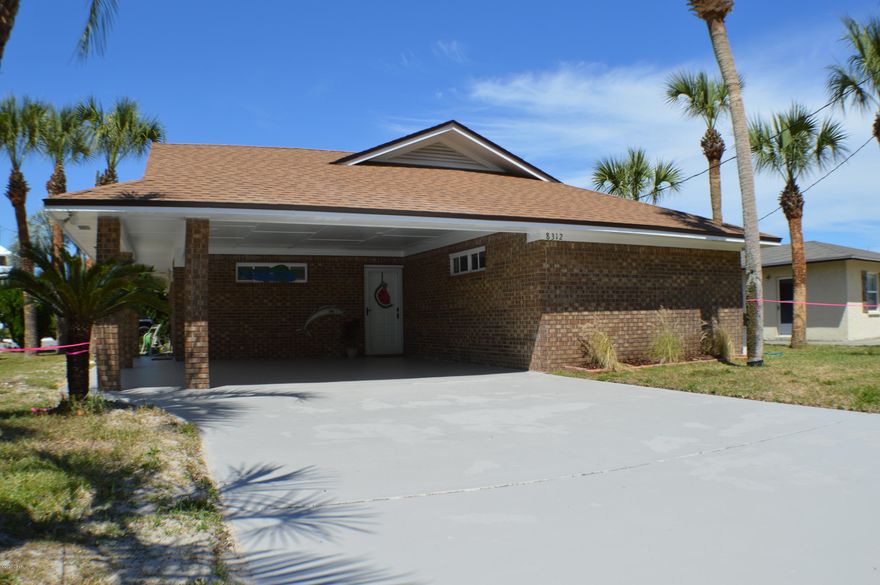 Currently under contract, seller accepting backup offers.  OWNER FINANCING AVAILABLE! Beautiful brick home with new roof, corner lot and literally right across the secluded drive from the gorgeous white sandy beaches of the Gulf of Mexico.  Only a few steps to the pubic access and you will be on  The World's Most Beautiful Beaches.  This home has never been a rental and has always had TLC throughout the seasons.  Completely upgraded home with beautiful new gray plank flooring, new paint, crown molding, stainless steel appliances, and granite countertops with new cabinets!!!!!

This home is on a corner lot and move-in ready.  Home also has an oversized two-car carport that can easily be enclosed if you choose.