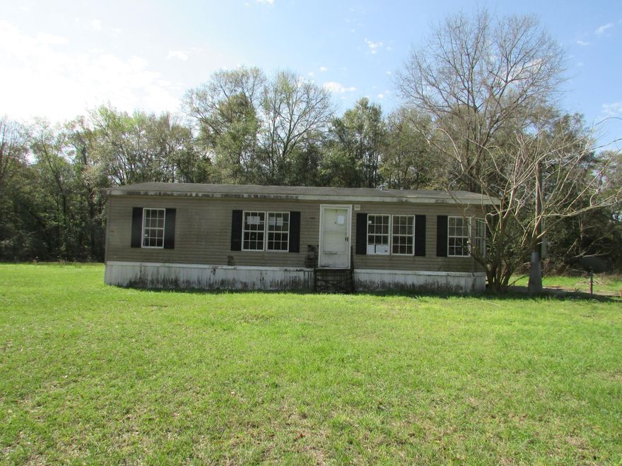 Located in the county but close enough to town sits this DWMH with 3 bedrooms 2 baths with 1296 sq ft  on 1 acre! Home needs some TLC, but can be the perfect home for your family.  Home to be sold in the AS-IS condition with no repairs.