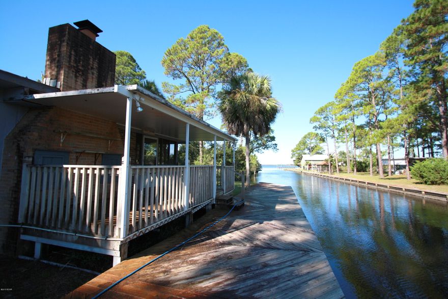 Waterfront living at it's best! Imagine yourself on the deck with a morning cup of coffee at the sunrises. Do you have a boat? If not, get one! This property has a dock and it is fronted by water on two sides. This truly unique water front home is tucked away in a private setting. Close to Marina Bay Condos and only yards from the open water of North Bay, this home features open floor plan, original brick fireplace, 2 bedrooms and 2 full bathrooms. Ready for your personal touches. The house has a lot of potential. Age, Square Footage, and room sizes approx., if important please verify.