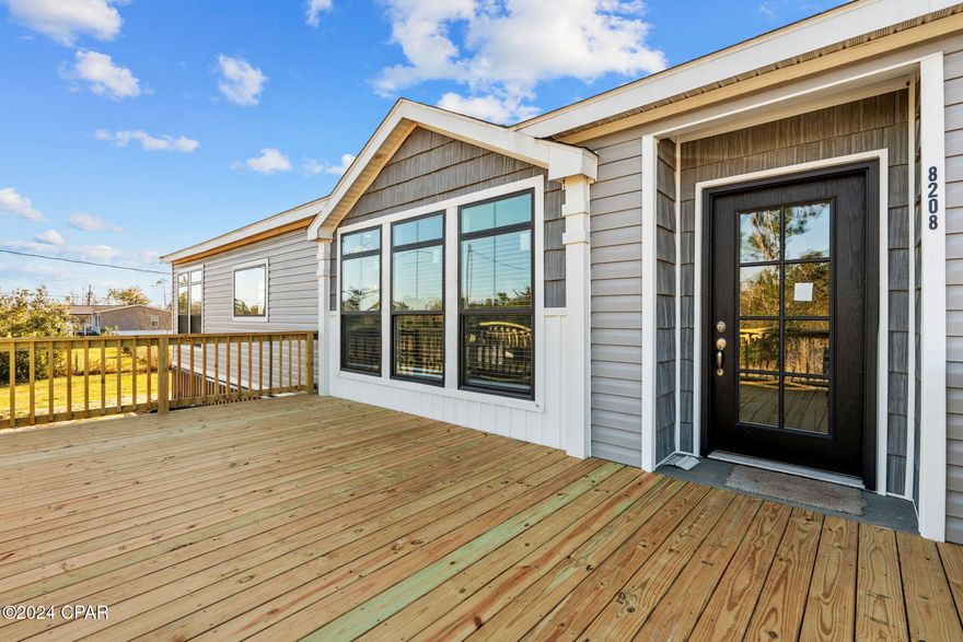 This 2022 home offers a spacious open floor plan with a beautifully contemporary style on a 1-acre lot. The modern kitchen features white cabinets, large island, new stainless steel appliances, and ample storage, flowing seamlessly into the living and dining areas. The master suite includes a large soaking tub, double vanity, spacious walk in shower, and fresh updates throughout. Outdoors, enjoy a brand-new deck perfect for relaxing or entertaining. With fresh paint, generous bedrooms, and endless outdoor possibilities, this move-in-ready home combines privacy and modern living! Just 19 miles from Tyndall Air Force Base. Located right off the highway you have easy access to local parks and beaches!