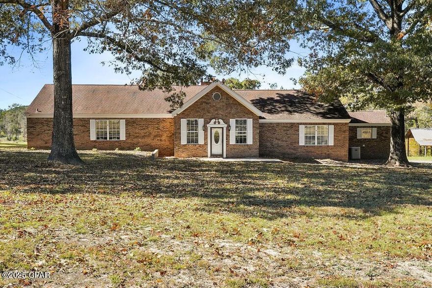 Privacy, Space, Charm—This One Has EVERYTHING
Experience privacy, acreage, and true North Florida living on this beautifully laid-out 21.29-acre estate, just 5 minutes from Bonifay—close to grocery stores, restaurants, parks, schools, police and fire departments, and more.

This spacious 4-bedroom, 3-bath custom-built brick home offers nearly 3,000 sq. ft. of living space with a smart, split floor plan designed for comfort and flexibility. The home includes two full primary suites, each with its own bathroom—ideal for multi-generational living, guests, or families who need extra space. All rooms throughout the home are exceptionally large, and each one features a walk-in closet, giving the entire home a comfortable, functional flow.

Inside, recent updates blend modern style with the home's original custom charm. Upgrades include new flooring throughout, new baseboards, and a gorgeous floor-to-ceiling backsplash in the kitchen. These enhancements elevate the home while preserving standout features like the 20-foot vaulted ceilings in the main living room, highlighted by 100-year-old beams salvaged from a historic local church.

A second living area—currently used as an office and photography studio—offers 12-foot ceilings and a bright, airy, versatile space for work or entertainment. Both A/C units were just serviced, and the roof has been inspected for added peace of mind.

Outside, the property excels in both usability and privacy. The home features a long paved driveway, along with two gated entrances, both located on paved roads. The acreage also fronts both paved roads, providing multiple access points without sacrificing seclusion. A wide power-line access lane offers excellent clearance for trailers, trucks, equipment, or large-vehicle maneuvering.

The land has just been cleared and graded, creating a clean, open canvas ready for pasture, livestock, gardening, recreation, or future building. Mature shade trees—including beautiful oaks that change color in the fall—add natural beauty, shade, and seasonal charm. And because daily living happens on the large covered back porch, the home feels wonderfully private as it overlooks open acreage and stunning sunsets.

An extra-tall 40×60 pole barn offers substantial covered storage for tractors, RVs, boats, or vehicles. The 1,900-sq-ft enclosed workshop is powered, versatile, and includes a large roll-up door—ideal for mechanical work, hobbies, or a home-based business. Inside is a bonus area currently used as a spacious home gym.

The home's orientation is a major lifestyle perk:
• The front porch faces east, offering peaceful, unobstructed sunrises
• The back porch faces west, framing unforgettable sunsets over your private acreage—where relaxing and entertaining truly happen

Enjoy your own ½-acre stocked pond—perfect for fishing, quiet mornings, and watching wildlife. With a thoughtful mix of cleared land, mature trees, and wooded privacy, the property offers both openness and seclusion.

Conveniently located near everything:
• 5 minutes to Bonifay
• 5 minutes to local schools
• 45 minutes to Panama City, Panama City Beach, Destin, Dothan, Enterprise, and 30A

Properties with this much usable land, storage, character, and true privacy rarely hit the market. Schedule your private showing and experience everything this North Florida estate has to offer.