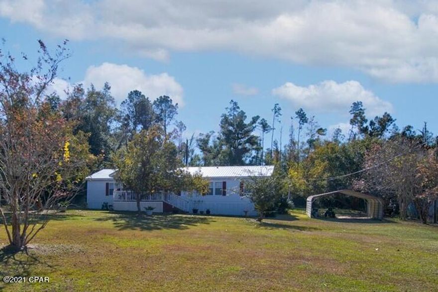 CURRENTLY UNDER CONTRACT, SELLER ACCEPTING BACKUP OFFERS - This perfectly sized & manicured yard will lure you into this cozy home. The property has been meticulously maintained & offers 3 bedrooms & 2 bathrooms. The roof & A/C are only 3 years old & the A/C offers an oversized heat pump. This lovely home is only 2 miles away from Three Rivers State Park, a short drive to Seminole Lake, about a 20-minute drive to the Marianna Wal-Mart, and i-10 is only about 10 min away. You can experience quiet country living while still being conveniently close to everything you need. The homes covered porch is a wonderful area to sit & drink your morning coffee & the neighborhood is quiet & beautiful. As you enter the home you will find a large living area with a wood burning fireplace along with a spacious kitchen & dining area. On the left side of the home are 2 generous size bedrooms with walk in closets & a bathroom. The master bedroom is conveniently located close to the living area & has 2 doors for easy entrance to the living room or laundry area. The master has a large bathroom w/ double vanity, garden tub, shower, & a huge walk-in closet. In the backyard you will find a back deck with a wheel chair accessible ramp & a large shed with a ramp. The shed includes electrical. Part of the backyard is fenced in -- perfect for the pets or for the children to play! There is a double carport on the side of the home for parking vehicles. The countertops in the kitchen & bathrooms have been resurfaced & updated. This home has been exceptionally well kept & maintained & will make a wonderful home for the next family.