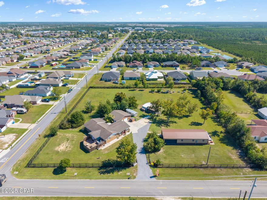 PRICE REDUCED FOR QUICK SALE! Great Opportunity! If you've ever dreamed of having space and privacy without giving up the convenience of town, this rare two plus-acre property with 3bed 2 bath/2 courtyards. This brick home is totally fenced with electric/solar gate and is the perfect find. It's just ten minutes from dining and shopping and about thirty minutes to the beach, offering the peace, space, and freedom of country living right where the action is.

You'll love the bonus of seven mature pecan trees that produce an annual harvest, plus the affordability of having your own well and septic already in place while still enjoying the advantage that county water and sewer services are available if you ever prefer to connect.

The land feels like your own private compound, fully fenced and gated with a solar electric entrance for both privacy and presence. A massive 24 by 65 foot metal building features three large roll-up doors, a bathroom, and a screened-in Florida-style pavillion that's perfect for entertaining, projects, or extra storage. There's also a 17 by 17 covered parking area, a 12 by 24 workshop, and an oversized two-car garage with plenty of space for tools, vehicles, or even a boat.

When the day's work is done, you can fly across the property on the zip line or unwind in the hot tub just off the main suite's private patio. Two outdoor living areas, each with fire pits, paver patios, and outdoor sinks, make this home an entertainer's dream and a peaceful retreat all in one.

Inside, you'll find over 2,100 square feet of well-designed living space. The spacious living room is bright and inviting, filled with natural light and views of the property. The kitchen stands out with granite countertops, stainless steel appliances, a breakfast bar, walk-in pantry, and a dedicated coffee bar. A formal dining room just off the kitchen offers the perfect spot for family dinners or gatherings with friends.

The layout includes two potential master suites, each with double vanities and private baths. The main suite opens directly to the outdoor living area and features a custom double shower, dual sinks, and a large walk-in closet with built-ins. The second suite includes a tiled shower and tub combo, while the third bath is handicap accessible. Fresh interior paint throughout gives the home a bright and welcoming feel.

Every detail of this property shows pride of ownership and thoughtful design. Whether you're looking for space to spread out, room to work, or a property that gives you the freedom to live, work, and play all in one place, 4738 Cherokee Heights Road delivers. Ask your favorite agent to send you the video on this one. 

This isn't just a home. It's a way of life — peaceful, spacious, and full of possibility.