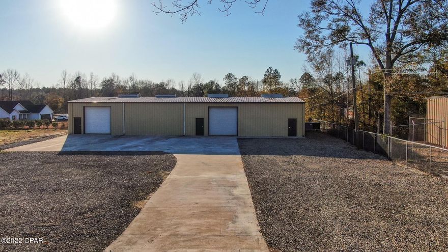 CURRENTLY UNDER CONTRACT, SELLER WILL CONSIDER BACKUP OFFERS - 5,000 Square Foot INDUSTRIAL WAREHOUSE ON AN ACRE OF LAND - Fenced and Gated! This property is conveniently located in the Tommy McDonald Sr. Industrial Park, which is 5-10 minutes to I-10. The steel frame insulated building is split down the middle with a removable wall.  2,500 SF is heated and cooled. The building features 14' ceiling, 2 12x12 ground level rollup doors, 3 exterior entry doors, new LED industrial lights, concrete floors, gutters, a utility sink and a bathroom (new fixtures) with capability to add a shower. The office has an exterior door, new LVP flooring and an adjoining storage or break room. The lot has a chain link fence all the way around with a roll gate entry, a large concrete driveway and parking pad with additional gravel parking, and the rest is completely cleared for additional use.  Call today for more information.