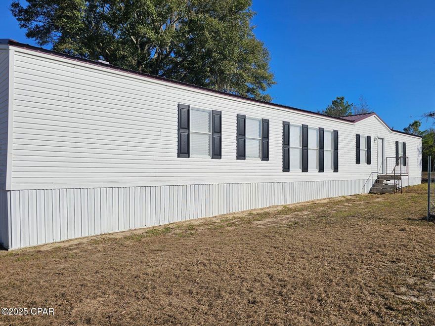 Completely renovated 3 bedroom 2 bath home located on a paved road in northern Bay County, just a short distance to 231. This home is located in just under an acre and is perfect if you want some country living.  The entire home has been redone and looks like brand new.   The paint in fresh inside and out, new shutters, new flooring, new countertops and sinks in the kitchen and baths, new light fixtures, new blinds and brand new fence with security gate PLUS a nice newer appliance package.   Buy this home knowing it is move in ready and needs nothing. Call your REALTOR today.