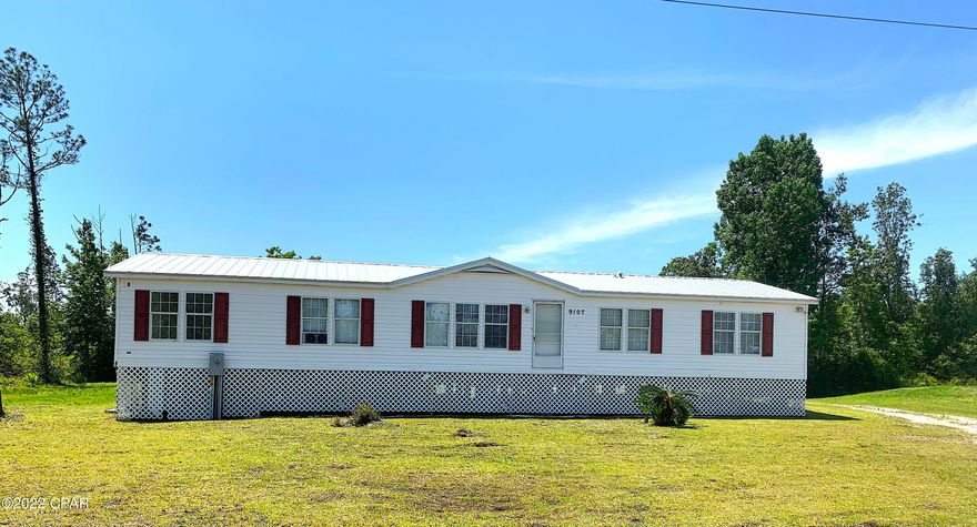 Here's a great opportunity to own a large, 4 BR (or 5 BR)  home, in a quiet area of Northeast Bay County.  This 1 acre property is within 15 minutes of TAFB and Panama City.  The lot extends West, approx 25' past the cleared area, and is full of blackberries, fig /fruit trees and wild grapes.  The driveway goes all the way around to the rear deck and back door, which is the most convenient access to the home.  Inside you'll find a huge greatroom, oversized kitchen, 4 bedrooms PLUS an office or 5th bedroom, that is accessible from the master bedroom or greatroom.  Seller has installed new wood-look tile flooring, and commercial grade carpeting, for long life and minimal wear.  There is new paint throughout, and the home is bright and clean.  Schedule an appointment to see this one today! *Information provided is deemed reliable but is not guaranteed and should be independently verified by the buyer*