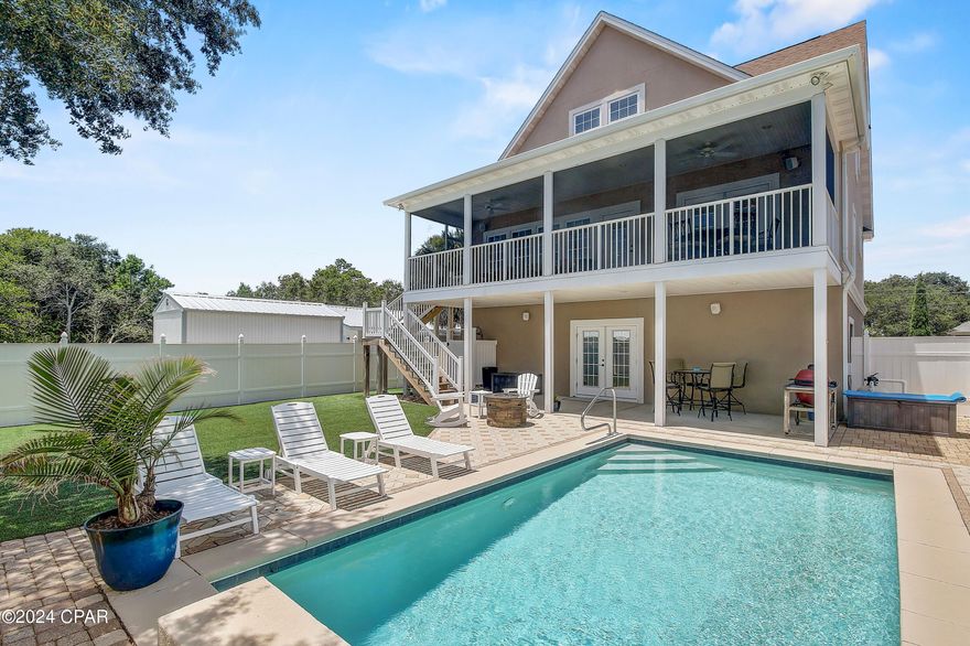 CURRENTLY UNDER CONTRACT SELLER WILL CONSIDER BACKUP OFFERS. INCREDIBLE BEACH HOUSE with FULL 2+ CAR GARAGE & GUNITE SALT WATER POOL featuring waterfall**ONLY 4 BLOCKS from the beach and GULF**Golf cart friendly community with NO HOA! Short term rental allowed with six figure income projections. Featuring custom enclosed outdoor shower, covered porches, firepit area, and privacy fence.  Located in the quiet sought after WEST END of Panama City Beach just minutes from Inlet Beach and Rosemary Beach with convenient access to fabulous restaurants and shopping on popular 30A or Pier Park...without the crowds! EASY BEACH ACCESS! The lovely terrace level features French Doors to private pool deck and convenient half bath (Could be finished for more living space).  INCREDIBLE STORAGE! Patio and screened porch are covered and full length with spacious private backyard and pool views. The Main level features kitchen full views of great room with custom built in bookcases and cozy electric fireplace.  You will love the unique rich classic espresso stained Hemingway style of the kitchen cabinetry and architecture! The kitchen cabinets are stained solid maple and include a built in desk.  The kitchen features stainless appliance package, natural light, recessed lighting, ceiling fan, granite countertops and full kitchen bar.  Oiled bronze lighting, hardware, brushed nickel ceiling fans, and REAL HARDWOOD FLOORS throughout.  Owner's suite is on mid main level and features double french doors to covered full length porch.  Recessed lighting, walk in closets, spacious bath with double vanities including oversized shower with dual shower heads. Massive walk in closets throughout! This floorplan is perfect as a potential short term rental.  The upstairs bonus room could be used as a media room OR you can create a 4th bedroom or bunk room with ultimate versatility.  You have options, as it would also be an incredible full time residence in this quiet community so close to the GULF. Plenty of closets and storage throughout. The backyard features pet friendly artificial turf for optimal low maintenance.  EVERY DETAIL WAS CONSIDERED in this custom home.  VIEWS of the GULF from west side of home! BONUS: this home features impact resistant windows AND Therma-Tru fiberglass impact resistant exterior doors that are hurricane grade giving the owner deep discounts for insurance according to current policy in place.  *All details to be verified by buyer.