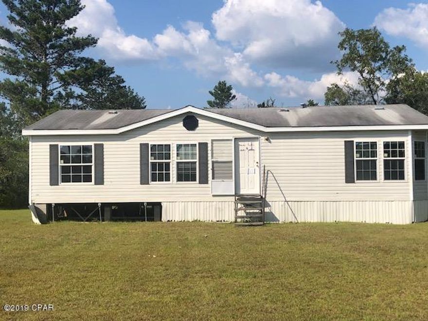 This double wide home sits on a nice corner lot across the street from the library in rural Calhoun County.  It is a great investment property with lots of potential.   It needs some repairs from hurricane damage but you will have a great place when you complete repairs.  It has a large living room with fireplace, split bedroom design  and a large eat-in kitchen.