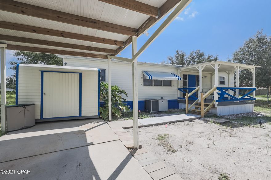 Spacious double wide with 3-bedrooms and 2-full bathrooms in a cul-de-sac in the quiet neighborhood of North Lagoon Oaks located on the East end of Panama City Beach, less than 3-miles from the sugary sandy beach and all the attractions and local restaurants. The seller has just installed a new septic tank, new carpet, and LVP flooring. There's a covered front porch and a carport on the driveway. The lot is 72x185 with lots of space in the backyard. No HOA, Flood Insurance is not required, the property is on flood zone X and sits next to a Bay County strip of land, so no neighbors on one side. Actual age of the mobile home (Title) is 1975. All information is deemed correct, buyers should verify if they are important.