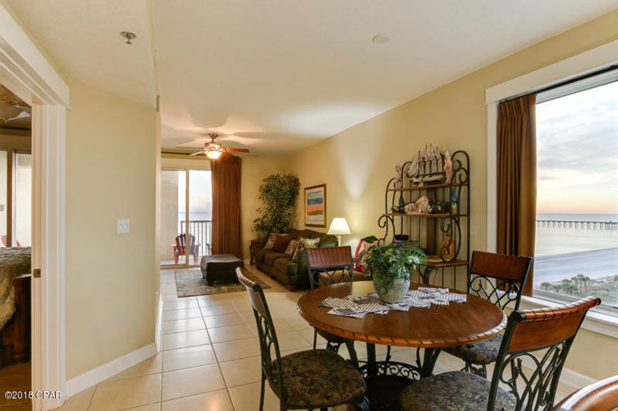 Luxe Gulf front living at the perennial favorite resort ~ Grand Panama. What a great price for 3 spacious bedrooms, 2 bathrooms and a bunk nook - you can easily sleep 10 in this perfect rental condo! Perfect elevation within the stack! The unit is being sold fully furnished. Many upgrades and decorator-perfect finishes to include hard surface flooring throughout. The kitchen has been upgraded with stainless steel appliances, granite countertops & breakfast bar, custom tile backsplash, and 20'' tile floors. New HVAC in '17! The Gulf front Master Suite opens to the large balcony, has a king bed, flat screen TV, balcony access, and en-suite bathroom. The master bathroom is exquisite with a large soaking tub, separate walk-in shower, granite countertops, double vanity, and tile floors. Grand Panama resort is situated on 35 acres including 14 acres of common areas with many resort style amenities and luxuries such as including: 6 pools, 6 spas, 3 fitness centers, 4 full service Tiki bars, an owner's lounge, playground, water slides, beach service, retail and coffee shops, meeting space, on-site rental desk, 24 hour security and much more. The Village of Grand Panama is also directly across Front Beach Road and features incredible restaurants, a coffee shop, and boutiques. Do not miss out on this opportunity to own an upgraded 3 BR Gulf front condo with the incredible amenities of Grand Panama Beach Resort!