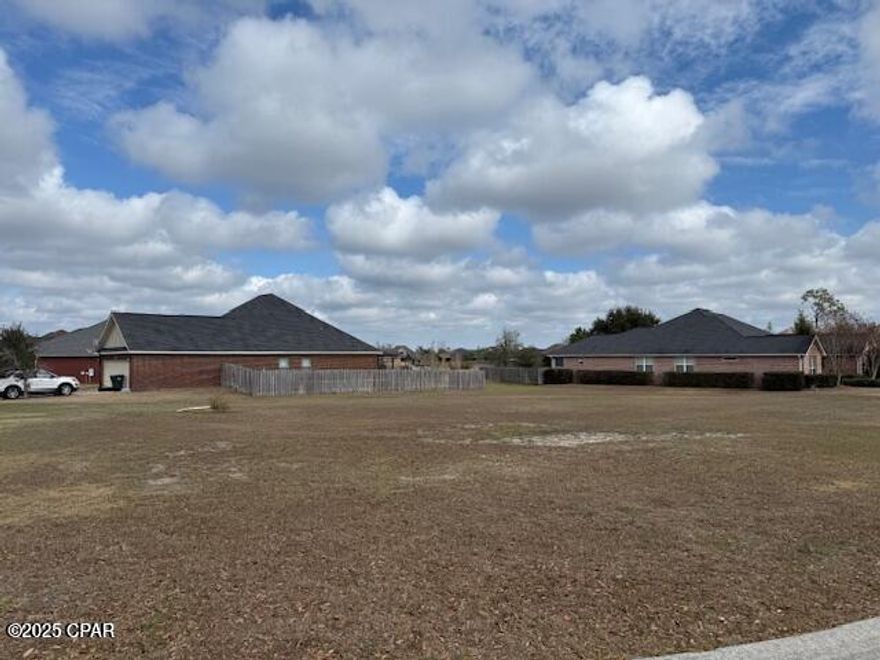 Large corner lot in The Meadows. Beautiful, cleared, pond access and ready to build, this .44-acre lot that is perfect for you! If you love golf, you are in luck, Nature Walk is just a golf cart ride away. Close to Panama City Beach, airport, shopping, restaurants and hospitals. Call today!