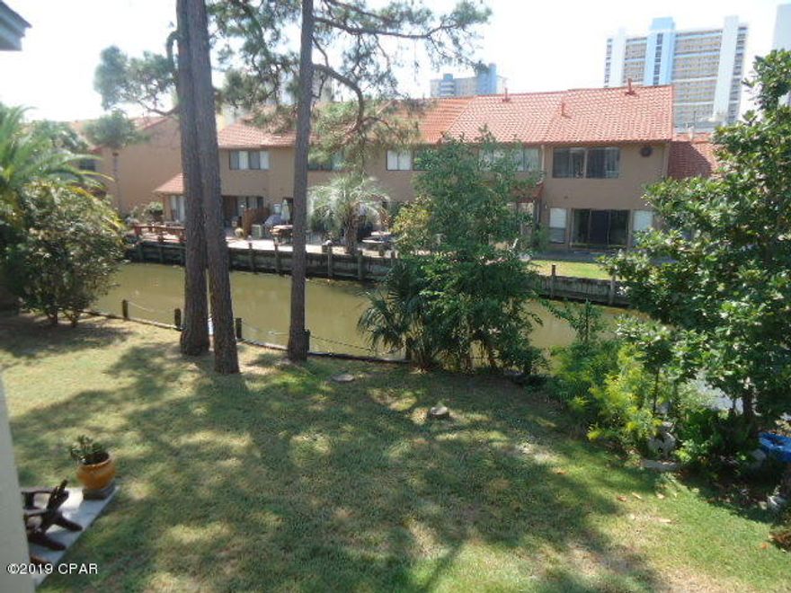 Come enjoy peaceful days sitting out by the Canal. This 2 Bedroom Townhouse has 2.5 Baths ~ ON THE CANAL ~ located in a Gated Resort that is WALKING Distance to the BEACH... Come see it! The HOA Dues are only $450 a Quarter NOT a Month and that pays for your  Basic Cable Package, Termite Bond, Household Trash, some Pest Control, Mowing your Lawn, and Lots of Amenities. Speaking of Amenities, there are 11 Pools ''5 Heated'', Shuffleboard Courts, Tennis Courts ''2 Lighted'', an 18 hole Mini Golf Course, Conference Center, Fitness Room PLUS there is a Private Clubhouse with a Snackbar and a Pool directly on the Beach and it is also ''Gated''!!! There is NO Extra Charge to use the amenities.  Age, SF, and Dimensions are approximate... please verify if important.