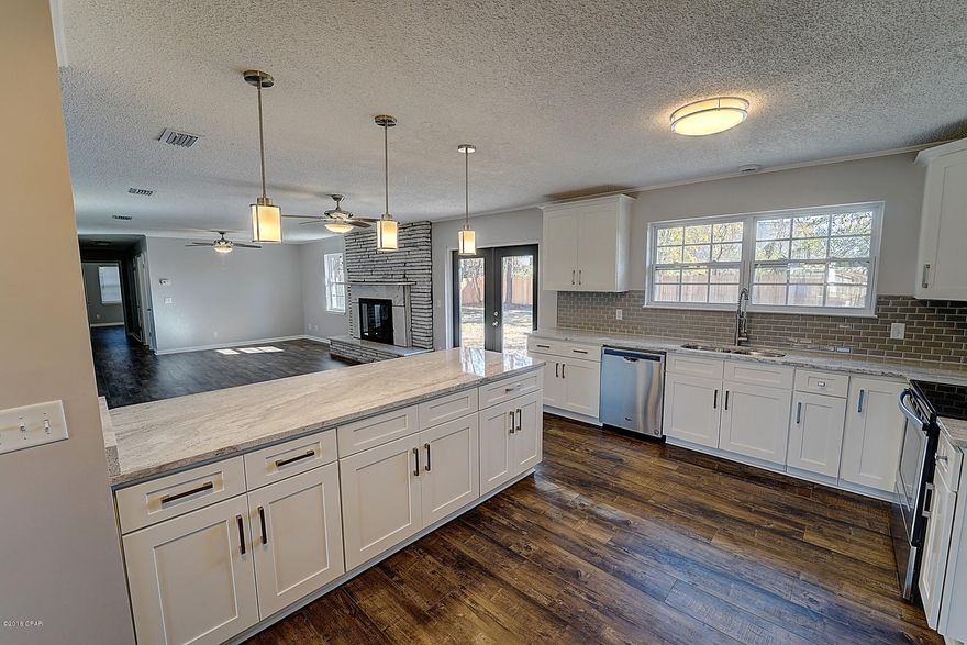 Like NEW,NEW,NEW!!! New roof,new kitchen, new windows,new HVAC,new water heater,new stainless appliances,new flooring,new fixtures. Wonderful all brick home on huge lot (over 1/4 acre) in FANTASTIC neighborhood with the most central location you could find! All granite counter tops, wood cabinets, fireplace, dble pane insulated vinyl windows. Amazing kitchen has tons of space, lots of counter & storage area,roomy closet pantry plus cabinet pantry for small appliances, double window at sink overlooking the big privacy fenced back yard. Family room is 17x26!!! Bedrooms are large with ample closet space throughout. Large utility room with space for a freezer. Lots of natural light. No carpet! Double car garage & circular driveway with plenty of parking! 3 bedrooms, 2.5 bathrooms 2,000 sq feet