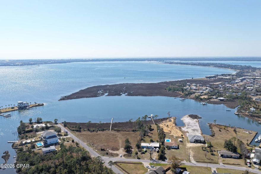 WATERFRONT HOME WITH GULF ACCESS!   PRIVATE POOL - NO HOA - Close to Tyndall AFB.  Enjoy entertaining or relaxing on the 0.87 acres of land. Check out the major improvements including the recently installed white SmartSide siding, considered a low maintenance but high-quality engineered product with a woodgrain look. The interior has had a major facelift as well. There are no words for the functional,   massive open space with the French doors leading out to a beautiful pool. There is the new kitchen with hard surface countertops, new appliances, new lighting, new soft-close drawers, new flooring, and a beautiful island with shiplap. In the other part of the house, you will find 2 updated baths. Close to the 'Base of the Future'', you are also a short ride to Mexico Beach. So much to offer! So little time before someone wanting a big yard and a nice waterfront. ''like new'' home snaps it up.