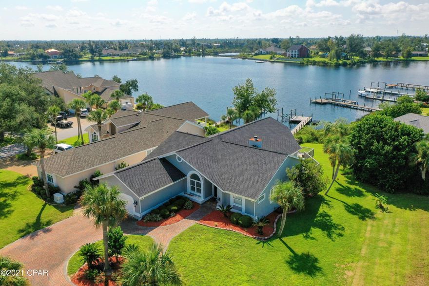 WATERFRONT 4 BED/3 BATH IN PRESTIGIOUS PANAMA COUNTRY CLUB!!!!  Impressive waterfront Panama Country Club home on Beatty Bayou which offers great fishing, water sports, and direct easy deep-water access to North Bay and the Gulf of Mexico.  EXTERIOR-features boat dock with lift, seawall, large covered and open deck, and new roof.  INTERIOR- Completely renovated with new luxury vinyl plank floors, lighting, paint, new A/C, and doors.  Kitchen features huge granite breakfast bar, stainless steel appliances, and wet bar with wine fridge and separate ice machine.  Formal living room with fireplace and large family room overlooking the water.  Large master bedroom with view of water and attached master bath with beautiful slate tile, large walk-in shower, separate whirlpool tub, and double vanity with granite countertop.