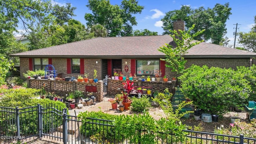 CURRENTLY UNDER CONTRACT, SELLER WILL CONSIDER BACKUP OFFERS' NEW SPECIAL OFFER! The Seller is offering a cash rebate at closing to be used for interior updating!  Nestled on a prestigious corner lot, this expansive brick home stands as a testament to timeless elegance in the heart of St. Andrews. Situated in a sought-after location, it offers the perfect blend of convenience and charm, just moments away from the tranquil Bay, the bustling St. Andrews Marina, and renowned local hotspots like Hunt's Oyster Bar, Dirty Ernie's, and Alice's Restaurant. Its proximity to downtown Panama City adds to its allure, promising a lifestyle of both leisure and urban sophistication. With its coveted location and classic appeal, this residence embodies the essence of coastal living at its finest. Welcome to this stunning residence boasting cathedral ceilings that grace the main areas, complemented by LVP flooring throughout main areas. The expansive layout includes not only a spacious living room and family room but also a generously-sized bonus room, adaptable as a second master bedroom or versatile living space.

Step outside to discover a resort-like oasis, highlighted by a magnificent 20-foot wide, 50-foot long gunite pool, reaching a depth of 5 feet at its center. Adjacent to the pool, an outbuilding beckons with a covered porch, offering both storage or workshop options,  this is alongside charming arbors and pergolas. Elevated seating areas provide panoramic views of the sprawling pool and patio, perfect for entertaining or tranquil relaxation.

Indulge in the ultimate comfort with sunrooms gracing the patio area, providing seamless access to both the main living area and and the master suite there is an outdoor showers too. Situated in Flood Zone X, elevated above flood risk, this home offers unparalleled safety and tranquility.

Perfectly positioned near the captivating attractions of the Bay, St. Andrews, and Panama City, and just a few miles from pristine beaches, this location offers the best of coastal living. The expansive master bedrooms exude elegance and comfort, while the meticulously landscaped outdoor space showcases a vibrant tapestry of tropical and indigenous vegetation, creating a serene ambiance. The pool equipment is all new, pump, vacuum pump, san filter tank.

Please note, potted plants are not included in the sale, although some may remain as a delightful addition to this enchanting setting.