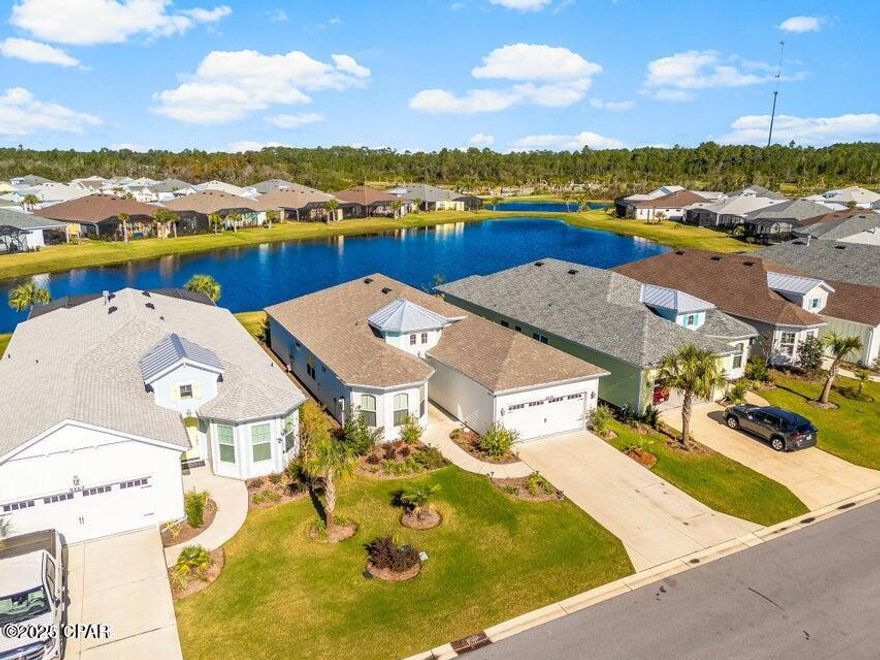 Here is your GOLDEN opportunity to purchase close-in phase 2 on a pond with incredible sunset views! Discover this gorgeous Parrot/Beach Collection home on a premium, pond lot in beautiful Latitude Margaritaville Watersound, a premier 55+ & better Community nestled along the Intracoastal Waterway just 7 miles from the Gulf of Mexico. Step in to an inviting open-concept living space, with an abundance of natural light and incredible sunset, pond views from the extended lanai. The kitchen overlooks the main living area and boasts quartz countertops and backsplash, beautiful crisp white cabinets with pull-out shelves, soft-close, crown molding on cabinets and upgraded/custom light fixtures, large island, and a stainless steel appliance package. Wonderful breakfast nook area with lots of windows. Formal dining room, perfect for dinner parties and holiday gatherings. Laminate flooring and custom interior designer paint throughout the home. A separate den/office with French doors. The owners suite offers a tranquil retreat with walk-in closets and an ensuite with dual vanity sinks, quartz countertops, and a over-sized, custom tile shower. Spacious guest bedroom, a full bathroom with a tub-shower combo, tile flooring, and wall tile. Two-car garage featuring epoxy coated floors, pull-down attic stairs with attic storage and plenty of room for 2 cars and additional storage. Plumbed for soft water loop/hookup. Extended, screened lanai with epoxy floors overlooking a peaceful pond, perfect for morning coffee, sunset cocktails or just an afternoon nap. This lot is absolutely perfect! Latitude Margaritaville Watersound offers world class amenities at the Town Square boasting a Bandshell, trex outdoor dance-floor, Barkaritaville Dog Park, and the Bar & Chill 2 story restaurant offering picturesque views of the Intracoastal Waterway. Additionally, indulge in the Resort-Style Paradise Pool, State of the Art Fitness Center with lap pool & spa, fitness classes, etc. Golfcart paths and walking trails are abundant throughout the community. The amenities include Tennis, Pickleball, basketball, bocce ball, cornhole, putting green, ping-pong, kayak launch, dog park, pet grooming center, woodworking shop, ceramic studio, theater & much more. A future Marina, grocery and commercial shopping/dining area just adjacent to the community. Health Care Campus within 5 miles to include medical offices, urgent care, outpatient surgical center and a future100 bed hospital. Phase 2 is within walking distance or short golfcart ride to all the amenities. This home includes a 10 Structural Warranty from the original close date. Come experience the Lifestyle Latitude Margaritaville Watersound has to offer!