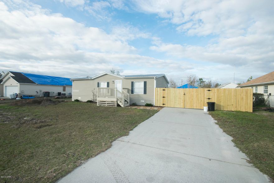 7307 South Lake Joanna, quiet, serene living in Sweetwater Village. Take a look at the photos and the aerial shots as well, a two bedroom home with two full baths, split bedroom floor plan and family room, kitchen and dining are all open. Upgraded vinyl plank floors, new carpet, new paint and polished clean! Located in flood zone x, flood insurance is optional. A double gate on the right side of the house allows for boat, RV storage, room for a workshop as well. Come visit today!