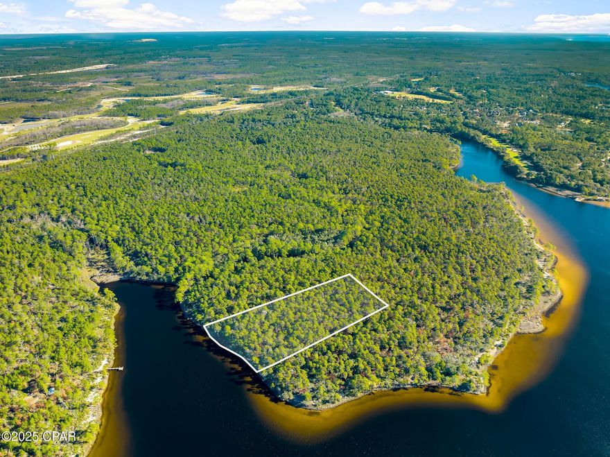 Nestled in a serene northwestern cove of Powell Lake—the largest coastal dune lake in Florida and North America, spanning nearly 800 acres—this expansive 5.58-acre lot offers exceptional development potential between the prestigious gated communities of Watersound Origins and Wild Heron. 

As ongoing residential and commercial growth in Panama City Beach continues to make Powell Lake shoreline an increasingly rare commodity, securing this waterfront property represents a golden opportunity in one of Northwest Florida's most dynamic areas.

Boasting approximately 300 feet of pristine shoreline on this ''Outstanding Florida Waters'' designated lake, the lot promises unparalleled privacy and a blank canvas for your vision—whether a custom dream home, private retreat, or eco-friendly escape. Its strategic location not only immerses you in the lake's tranquil ambiance, ideal for boating, jet skiing, or paddling, but also places you near top-tier amenities like the Greg Norman-designed Shark's Tooth Golf Course at Wild Heron and the resort-style pools, nature trails, and golf options at Watersound Origins. 

Just a short drive away, Panama City Beach's booming 2025 developments—including new attractions like TopGolf, Pirates Voyage Dinner & Show, and expanded parks—add even more appeal for lifestyle and investment potential.

Bay County has enhanced recreational access with a self-service kayak rental kiosk at the Lake Powell boat ramp, making this body of water even more inviting for paddle enthusiasts from sunup to sundown. 

Imagine crafting your ideal haven here, where the raw beauty of nature converges with the promise of luxury living amid Florida's Emerald Coast. With the region's rapid evolution, the time to seize this unique waterfront gem is now, before it's claimed.