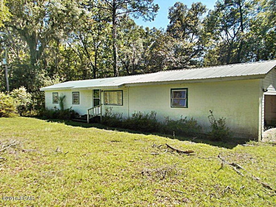 Conveniently located home on Hwy 90 just outside of Marianna, this 2/2 home needs some TLC but has lots of character, plenty of privacy from the road with over 800 ft of Hwy 90 road frontage and 15 ac. There is also a natural pond with a dock that needs repair on the back of the property that was stocked at one time. Need a workshop there is a 20x20 workshop with an attached 20x40 pole barn for equipment. Call agent today to view this home.