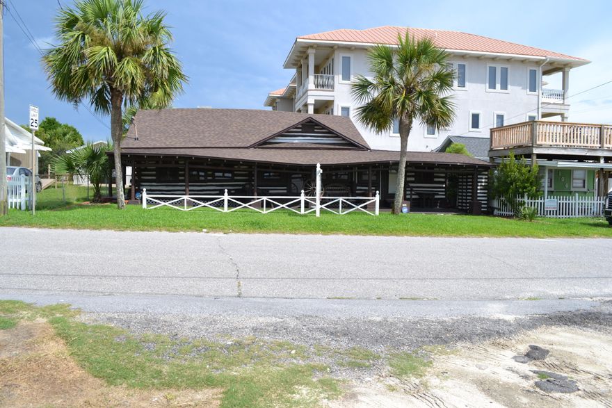 Wonderful opportunity to live just feet from the Gulf of Mexico! This log cabin is a great buy for air b&b or family use. Great beach access and near all of Panama City's hot spots. It is zoned commercial and could be a development opportunity for up to 50' or 4 stories. It is being sold furnished with some exceptions.