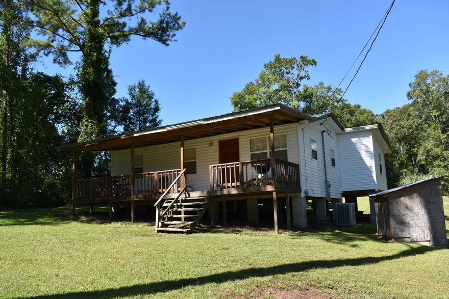 Located just outside the quaint town of Graceville sits this updated cute and cozy 3 bedroom/ 2 bath home.  Updates include newer windows, carpet in bedrooms and interior paint. Home features a split bedroom floorplan, oversized master bedroom with large master bath suite. The original, beautiful hardwood floors can be found in multiple rooms through out. Outside you will find a small lean to perfect for storing your lawn mower or ATV, a 16'x16' multi-purpose out building with window unit that is completely finished on the interior. There is currently no plumbing running to the out building but it could easily be added if desired. Home is built on the side of slope which allows for the possibility of the bottom portion being closed in to create additional outdoor storage. All of this and more on 1.24 acres.  Don't miss out on this property, call for your viewing today!