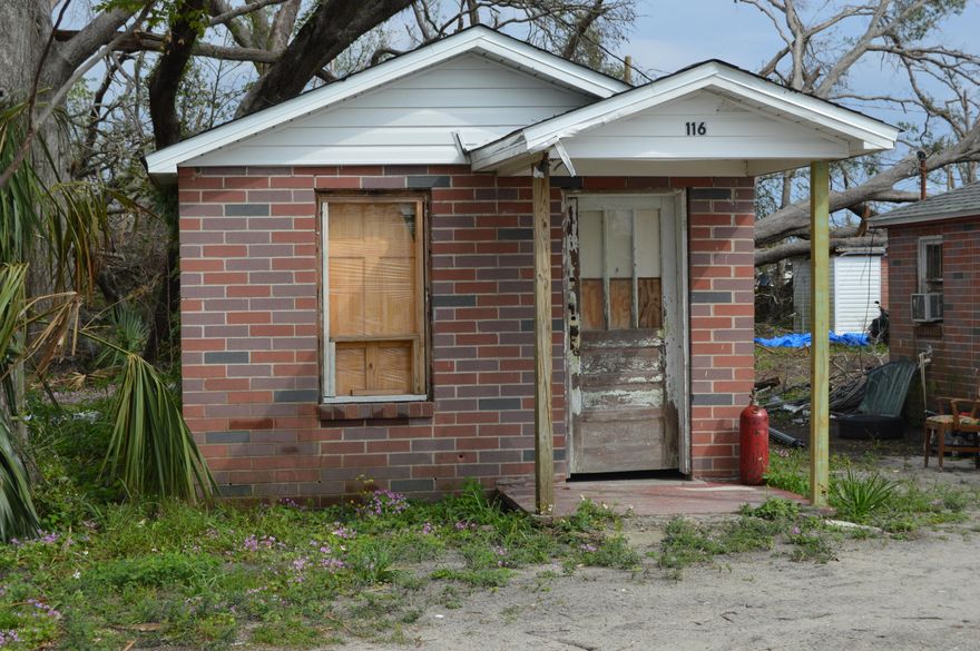 7 Single Family 1 bedroom efficiency floor plan homes all on one corner lot. One unit has a tree on the roof and one unit experienced a kitchen fire and both have not been repaired.  Each unit was rented out on week to week lease.  May make great temporary accommodations for out of town workers.  Two units have their own water and electric meters, remaining are all on one meter. Come see the investment potential and location before someone else does and buys this investment property.  Do not disturb Tenants.  Buyer to verify all info including zoning if important.  Make an offer on this income producing property today!  Call for your private showing.