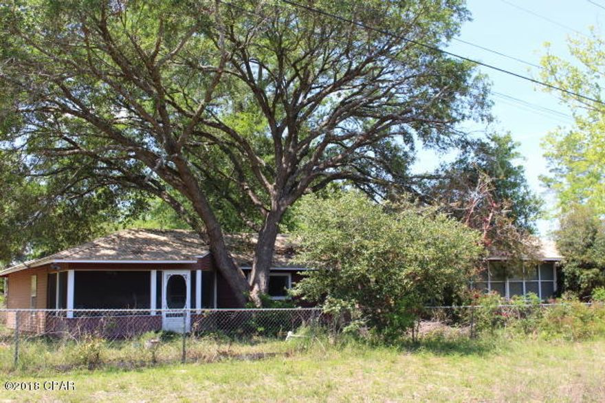Large family home located just a 1/2 hour or so to Panama City Mall. Original part of the home consisted of the large living, dining, kitchen (which could be turned into storage) 2/2, sunroom & carport. Kitchen was added along with laundry room, small family room, 2/1, laundry and screen porch. The large kitchen with walk in pantry has a built in butcher block counter top in front of picture window, Jenn-air cook top with grill, Separate smooth top stove/oven. Recess lightning. The kitchen center island also serves as a breakfast bar with a vegetable sink for easy prep. Open DR/LR. Gas Fireplace with built in bookcase. Tongue & groove ceiling. Front sun porch H/AC vent and ceiling fan & smoke detectors. See more remarks.. Original part of home consist of: Kitchen: sheet rock & brick walls, old dishwasher, 50 gal water heater, exit to carport on northend of house, vinyl flooring & 1/2 wood ceiling. Bathroom off DR: Carpet, panel walls, built in cabinet, newer vanity sink granite top, tub shower combo, GFI, crank windows, 2 panel wood door. Bedroom: back northend of house. Carpet, sheetrock walls, small closet, wood flooring, crank windows. End of Hall, previously a 1/2 bath: water heater, sink hookup, vinyl flooring, panel walls, crank window. Bedroom, back westend: Sheetrock walls, wood flooring, 2 closets, one original second, large walkin adjoins large bathroom. Part of new addition, Bathroom with whirlpool tub, handicap accessible, separate shower, marble vanity, carpet, sheetrock walls, glass block window, GFI, adjoins laundry room which has exit door to carport & storage buildings.. Southend of house, 2/1 addition along with a small family room and screen porch. Berber carpet, sheetrock walls, Additional bathroom with tub/shower combo, marble vanity. Most of the property is fenced. Room for garden. Landscaped with flowering bushes.