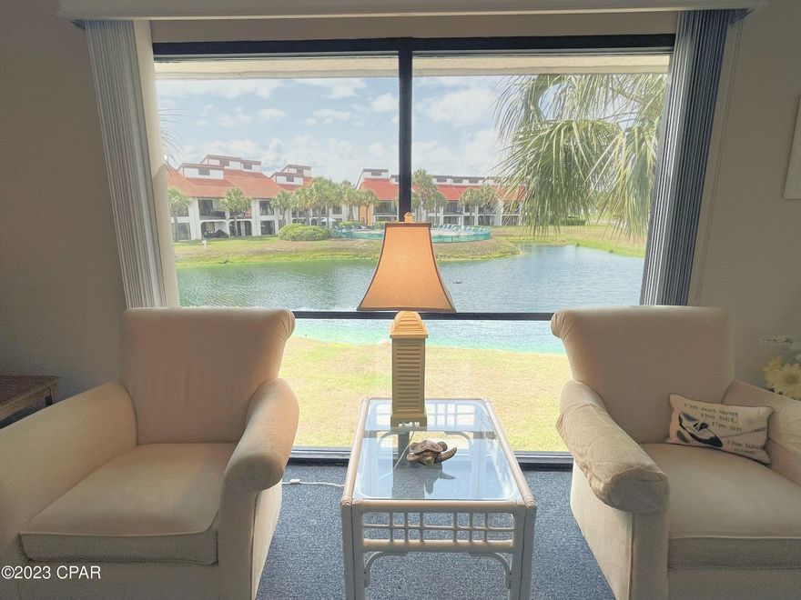 This extra-large End Unit at popular Edgewater Beach Resort is a coastal oasis in a beautiful location. It is offered fully furnished and will be a strong rental with just a few more updates. Sellers have owned for 15 years, and it is a well-maintained, non-rental condo on the second floor (no elevators). Enjoy a tranquil pond view through floor-to-ceiling windows to the inviting Villa pool. Relax on the private, covered patio for morning coffee, breezy nap or evening meal. The spacious owner's suite has balcony access and an en suite bathroom with walk-in tile shower. The oversized second bedroom easily accommodates two queens, features its own private balcony, and has convenient access to the guest bathroom. There is a full kitchen with updated cabinetry, breakfast bar, dining area, pantry and standard-sized laundry. This special condo is just across the street from Edgewater's secure beach access and unparalleled waterfront amenities - walk the skybridge or grab the tram! Indulge in the true resort lifestyle that Edgewater promises with tropical pools, hot tubs, waterfalls and breathtaking sunsets. The incredible onsite Ocean's Restaurant & Bar serves delicious food and is unmatched by any other local resort. Edgie's Corner Market promises everything you forgot at home, fragrant Starbucks, refreshing ice cream, and more. Get active with golf, tennis, pickleball, shuffleboard or time in the fitness center. Bella Salon services available by appointment. Fun splash pad and planned activities for the kiddos. Gated street and beach entrances for peace of mind. There is incredibly convenient, gated building-side parking with dedicated spaces for electric vehicle charging, RVs, boats, and trailers. Walk to shopping, dining and entertainment right across the street at The Shoppes. Only minutes from exciting Pier Park and PCB's only dog beach!