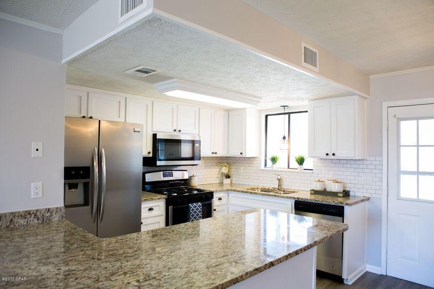 2 BLOCKS from The GULF OF MEXICO!! This adorable townhouse is COMPLETELY remodeled, along with all new appliances, new granite counters throughout, new flooring, new paint, new light fixtures, new shower, new back porch and much more! It is great location, 2 blocks from the Gulf within walking distance of the white sandy beaches.