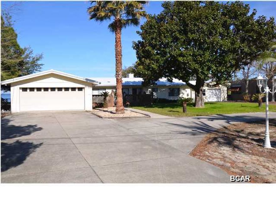 ST ANDREWS BAY! Want a spectacular view? Awesome sunset 365 days a year! Home situated on 150' of deep water frontage. See additional photos for pictures of dock w well built boat slip. Excellent location ... 5 minutes or less to Gulf Coast State College and Panama City extension of Florida State University ... 10 miles or less to Pier Park and beautiful Panama City Beach. A/C, & roof were replaced in 2002 & plumbing was redone in 2003. This waterfront home has 4 bedrooms & 3 full baths. The master suite was added just a few years ago. Bath features a corner whirlpool tub with glass block & separate ''man size'' shower, toilet, counter with built-in drawers and large walk-in closet. Home has a Rain Soft water purification system for entire house. In addition to large attached garage there is also a detached garage. Septic System installed in late 2014. What a deal! Square footage, lot size, room sizes should be verified for accuracy. Call today for private showing!  PRICE FIRM!