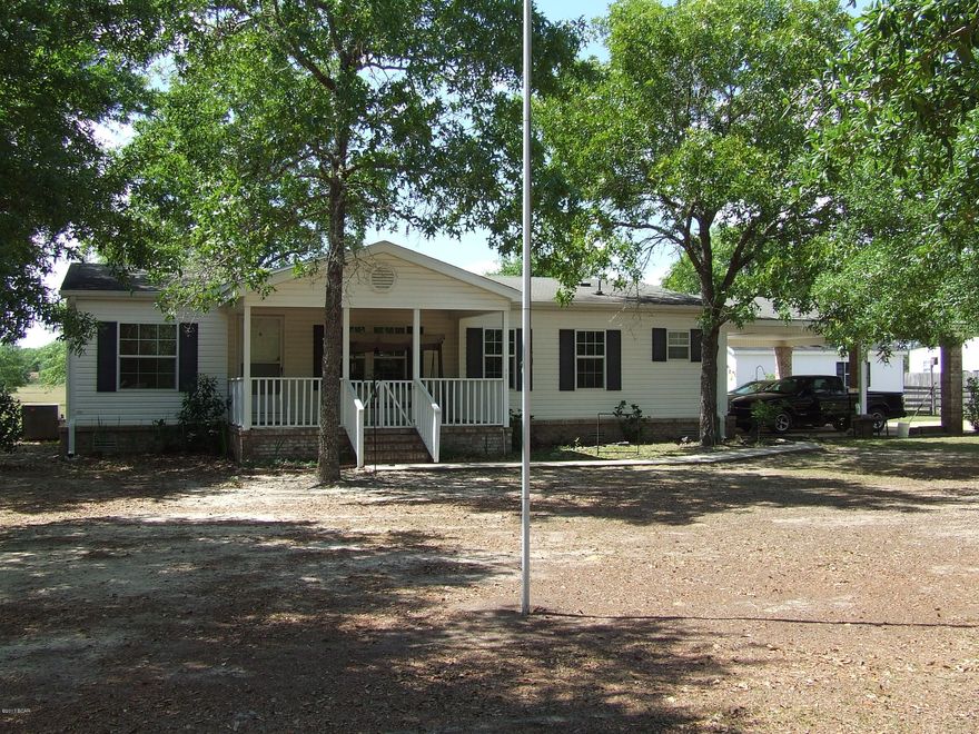 Convenience to the Beach, Tallahasseee, Dothan, or Panama City??? You have found it here in this spacious double-wide manufactured home located on a large lot less than 2 miles from Compass Lake!  Plenty of shade trees or sit on the porch or deck and rock away.  24 x 36 Pole Barn to store your boat or equipment under.  16x24 Utility Building to store outdoor equipment or customize for a man cave. Home is completely bricked in around the bottom  and there is a very nice attached 26x28 carport.  Don't miss out on this one, call today for a showing appointment.