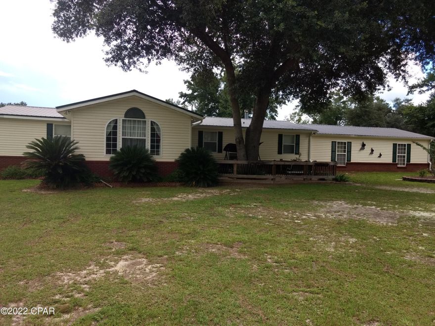 This is a must-see place. Original home is a custom built double wide with 2x6 walls and 3/4 Toung and groove ply-wood sub floor with 3/4 hardwood for the finish flooring. Beautiful craftmanship throughout. Owner added a double car garage, Large Den and Florida Room with Hot Tub. All under a new metal roof.  Has a saltwater pool with new liner. Pool shed; and a large RV shed with storage room. There is a copy of more large pole barns with concrete floors. There is a completely finished building that is being used for a game room, workout room and tanning bed. All this and much more on over 7 acres of well landscaped yard that is completely fenced. Also has a nice fishpond. Seller will finance the property with a 40 % down payment. At 6% interest for 15 years.