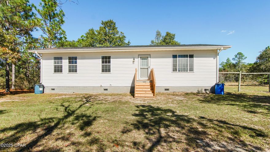 EXPERIENCE QUIET COUNTRY LIVING ON FIVE BEAUTIFUL ACRES!

This well-maintained 3-bedroom, 2-bath home offers the perfect blend of privacy, functionality, and outdoor living just minutes from downtown Defuniak Springs. Set back from the road and surrounded by mature trees, this property provides a tranquil escape with plenty of open space for hobbies, livestock, or gardening.

Inside, you'll find an inviting open-concept layout with tile and laminate flooring throughout, a spacious living area, and a kitchen featuring a large island, breakfast bar, and all major appliances. The primary suite includes a walk-in closet and private bath with step-in shower, while two additional bedrooms and a full guest bath offer comfortable accommodations for family or guests.

Step outside to enjoy the fresh air from your fenced backyard or take advantage of the detached 32x60 workshop/pole barn — ideal for equipment, storage, or hobby use. The wide drive and additional parking area easily accommodate boats, RVs, or trailers.

With no HOA, agricultural zoning, and a private well and septic, this property offers both freedom and functionality. Just a short drive from schools, shopping, and Lake Defuniak, you can enjoy country serenity with convenient access to town amenities.

Whether you're starting a homestead, downsizing to peaceful acreage, or seeking room to expand — this welcoming home is ready for your next chapter.