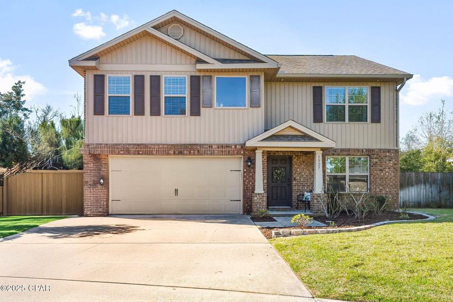 CURRENTLY UNDER CONTRACT, SELLER WILL CONSIDER BACKUP OFFERS. This spacious 5-bedroom, 3-bathroom home is located in the heart of Lynn Haven on a quiet cul-de-sac! The first floor features luxury vinyl plank throughout, along with a den/flex room that can be used as an office, formal dining room, or second living room, perfect for large or multigenerational families.  The first floor also features an open concept living room, kitchen, breakfast room, first floor bedroom, full bathroom with walk-in shower, and an attached 2-car garage with an additional first floor laundry hookup. The spacious kitchen features a large island with granite countertops, recessed lighting, maple cabinets, and a sizable pantry. Upstairs, you'll find a spacious second living area, ideal for a playroom or office space and a second laundry room. The primary bedroom is exceptionally large, with a luxurious ensuite featuring a dual vanity, bathtub, shower, and walk-in closet. The three additional upstairs bedrooms are also roomy, complemented by another full bathroom with dual vanities. The fully fenced and private backyard provides ample space for family activities with a new low maintenance composite deck, new sod and sprinkler system. The backyard is lined with beautiful trees with no neighbors in sight! Plus, the home comes with a security system for added peace of mind. Don't miss out—contact your favorite realtor today to schedule a showing before this home is gone!