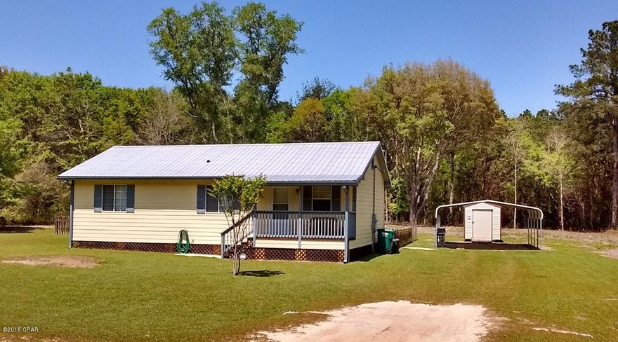 Adorable 3 bedroom, 2 bath, 2 car carport, shed with electric on 1 acre level cleared lot ready for new owners.  This home is super clean, move in ready with many updates since 2015.  Updates include: metal roof, AC, well tank, exterior doors, 2 toilets, gutters, interior/exterior paint, refrigerator, washer, partial fenced yard for pets/kids & so much more.  Centurylink internet is available and connection hard wired to living room for any device needed to stream TV, movies or gaming.  Quite relaxing setting with all the amenities Compass Lake in the Hills has to offer.  McCormick Lake, exclusively for property owners, is about a 3 minute drive.  The home is just over 16 miles to Marianna & 45 minutes to beautiful Panama City Beach.  Perfect starter home, retirement home or 2nd home.