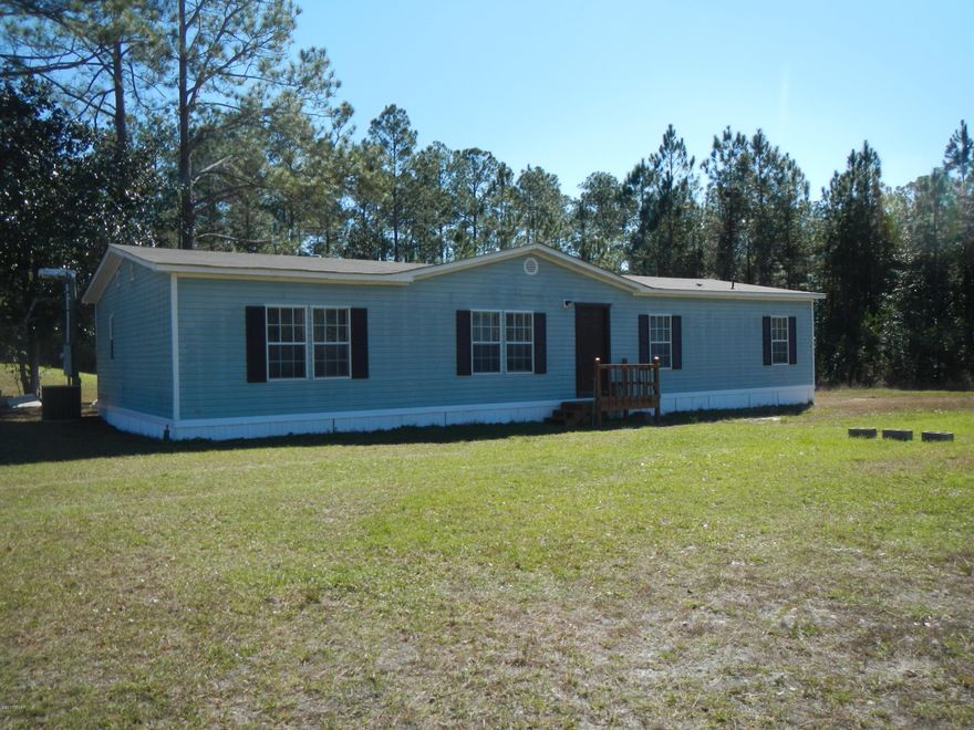 If you want a country setting not far from town, then this is a property to consider.  Large mobile home with two separate living areas, fireplace, split bedroom plan, laundry room, vaulted ceilings all on just shy of 5 acres.  Make your appointment to see this home today! Buyer to verify all measurements.