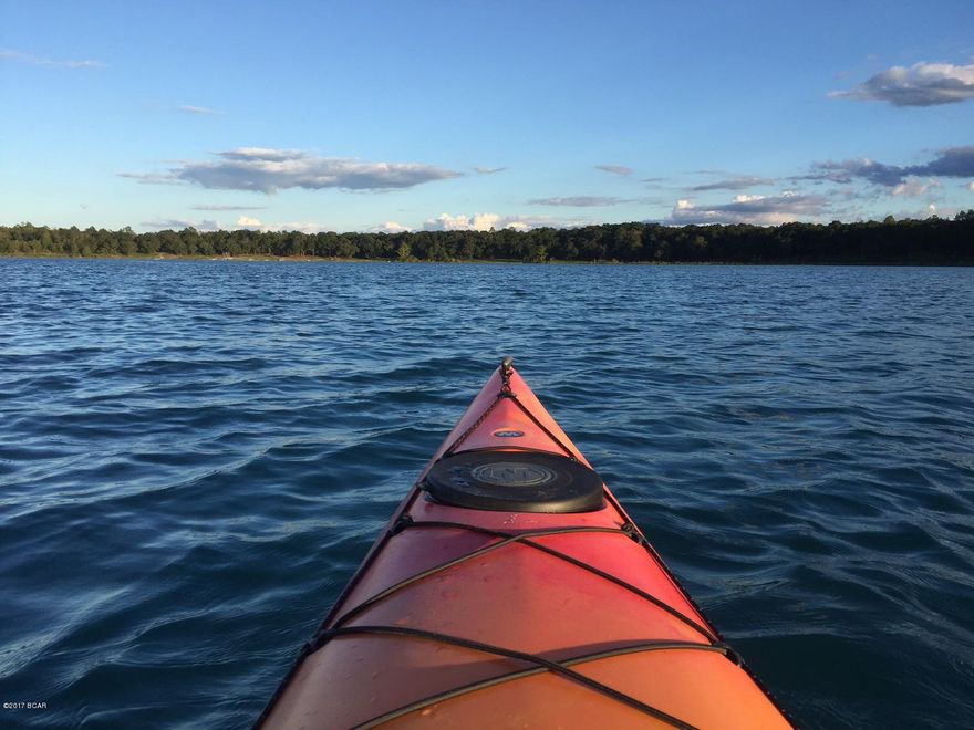 Don't settle for a 2.84 acre lot that does not have gated security or amenities such as a two large lakes, boat launch, sandy white beach, good fishing, boating, kayaking, swimming, swimming pool, toddler playground, tennis court, basketball court, restrooms, exercise room and more. That's what you get in the security gated community of Leisure Lakes, about 30 minute drive from Panama City, just off Hwy 77. This lot is a carpenter's dream, flat as a board. It has some nice hardwood oak trees and right across the street from a clear lake that is about 1 mile across, or about 3 miles around. Do not purchase a lot for your new house until you take a tour of Leisure Lakes and all the community has to offer.