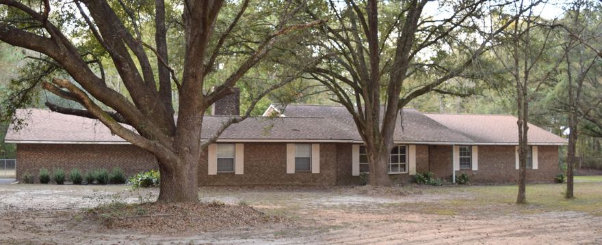 **COMMERCIAL OPPORTUNITY**. This 3/2.5 home located off Hwy 77 is currently being used as Residential but is zoned Commercial. Lot features 1.42 acres, 261 feet of Hwy 77 frontage and located next door to Sonic, within eyesight of Interstate 10. Building offers 6 potential large offices, a conference room, 2.5 baths, spacious utility room, full kitchen and new central HVAC. Outside you will find large workshop with lean-to, asphalt driveway, 2 car attached carport and lots of opportunity for additional parking.