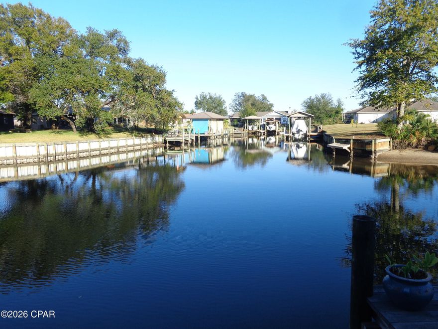 IMMACULATE - UPDATED- SPACIOUS WITH OPEN GREATROOM/ KITCHEN OVERLOOKING NAVIGABLE
CANAL. THERE IS A 22'X22' COVERED DECK/ PATIO OVERLOOKING THE CANAL, AS WELL. THERE IS AN UPDATED SEAWALL AND DECK TO PARK YOUR BOAT AT YOUR BACK DOOR, 21'X10'. --- THERE IS EXTRA CLOSETS IN THE HALLWAY AND DOWNSTAIRS AND A PANTRY.  TONGUE AND GROOVE CEILINGS. COMBO OF TILE AND VINLY FLOORS. NEW WATER AND SEWER LINES AND FIRE HYDRANTS.  LOTS OF STREETS HAVE BEEN REPAVED WITH NEW CURB AND GUTTERS. 
THE LAUNDRY ROOM CAN BE LOCATED INSIDE OR IN THE GARAGE. THERE ARE 2 BATHS UPSTAIRS AND A HALF BATH ON THE 1ST FLOOR. UPSTAIRS,
OVERSIZE MASTER BEDROOM THAT OVERLOOKS THE CANAL OUT BACK. 2 SEPARATE CLOSETS, 1 WALKIN. NEWLY UPDATED TILE SHOWER, 7'X4', WITH SEPARATE TOILET AREA. -- RECENTLY UPDATED  KITCHEN WITH GRANITE COUNTERTOPS. ALSO, A LARGE ISLAND WITH SEPARATE PORTABLE GRANITE TOP ISLAND.  THE LIST GOES ON !  LOTS  OF AMENITIES TO SEE AND ENJOY. THIS HOME HAS BEEN ALMOST TOTALLY UPDATED ! THIS IS A RARE FIND AND BEING ON THE WATER REALLY LETS YOU PLAY A LITTLE.
CALL TODAY FOR AN APPOINTMENT. !!!