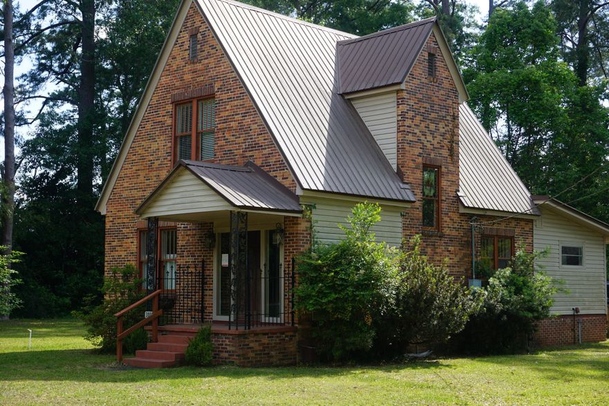 Beautiful Tudor style home located right in the middle of downtown Marianna. This home is completely move-in ready. This cozy home features large living space downstairs with hardwood floors throughout and vinyl flooring in kitchen. Master bedroom and bath is located downstairs with the two additional bedrooms located upstairs. This home has plenty of southern charm with a large in town lot. It is centrally located between all of the local schools and convenient to plenty of dining and shopping. The owner will be adding some additional renovations in the next week or so. These include: NEW AC unit, New back door, black appliances including refrigerator, and having all carpet professionally cleaned. Owner is a Licensed Florida Realtor.