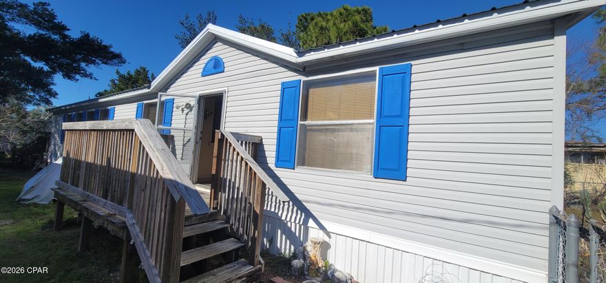 Welcome to your coastal retreat in the heart of Laguna Beach! This charming three-bedroom mobile home offers the perfect blend of comfort, convenience, and laid-back beach living. Located south of Highway 98, you're just half a mile from the sugar-white sands and emerald waters of Panama City Beach, with scenic trails leading straight to the beach and golf-cart-friendly streets throughout the community. Whether you're looking for a primary residence, second home, or investment opportunity, this property offers excellent flexibility for short-term rental or full-time living. Enjoy the freedom of a no-HOA community, allowing you to personalize and use the property to fit your lifestyle. The low-maintenance yard, gravel driveway, and fenced backyard provide ideal space for golf cart, boat, or additional storage. Unwind on the back deck after a day at the beach, perfect for outdoor dining or relaxing in the coastal breeze. Just 5 miles from 30A, this home is close to dining, shopping, and entertainment while still offering a peaceful beachside setting. With minor refreshing such as a fresh coat of paint, this property's charm and appeal can truly shine. Don't miss this opportunity to live or invest in one of PCB's most desirable coastal locations.