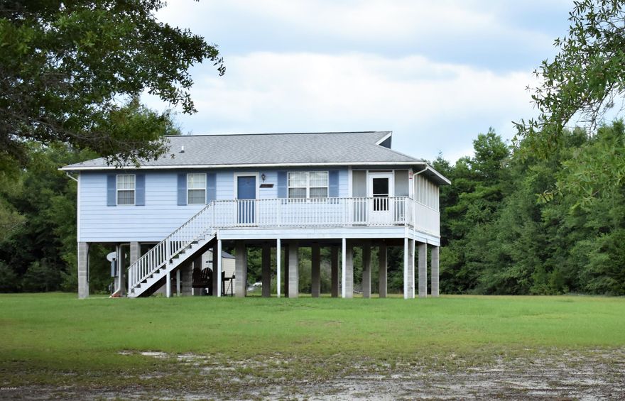 CURRENTLY UNDER CONTRACT, SELLER ACCEPTING BACKUP OFFERS! FISHERMAN'S PARADISE & a perfect getaway retreat.  Home is nestled in the Wildlife Management Area & only 1/2 mile from Bear Hewitt Boat Landing on the Choctawhatchee River. An additional 192 sq ft can be added by installing windows into the enclosed sun-porch which is already ducted for HVAC & has ceiling fans.  There's a 10' x 20' bunkhouse/guest quarters that has a full bath & is air conditioned.  The massive 32' x 72' pole barn has plenty of room for parking & there's also RV hookups.  Home is built well above flood level & is on concrete block pilings reinforced with steel rebar & poured with concrete. Relax on the swing on the shaded patio underneath the home with plenty of storage to include multiple outbuildings.