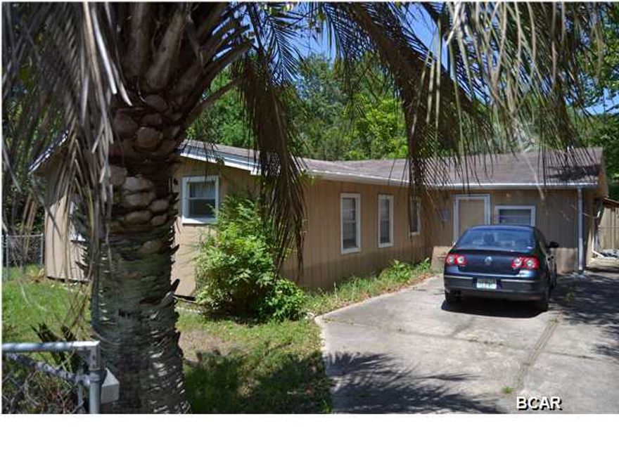 Very secluded 3 bedroom, 2 bath home located on a less traveled road and on a wooded lot. This home is a hidden gem yet close to Tyndall AFB, shopping and schools. The interior of the home has an open concept with a large living room with hardwood floors and a fireplace. The kitchen and dining area overlook the living area and have access to the fenced in back yard. All 3 bedrooms are large and the master is HUGE! The lot is 75 feet wide and 321 feet deep and features a large detached shop and another large outbuilding with a fish cleaning station and more storage. The lot is wooded and has plenty of room to expand your new kingdom!! Call today for a private showing