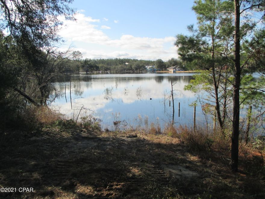 BEAUTIFUL LAKEFRONT ACREAGE - Looking for a lakefront property that offers privacy, great views and room to grow?  This is it.  This 12.6-acre parcel is surrounded by beautiful, well-kept homes, sits high along the shore of Piney Lake, has no HOA and is on a paved road.  It is 25 minutes from Northwest Florida Beaches International Airport and 45 minutes from Panama City Beach.  Call to schedule your visit today.  Measurements are approximate.