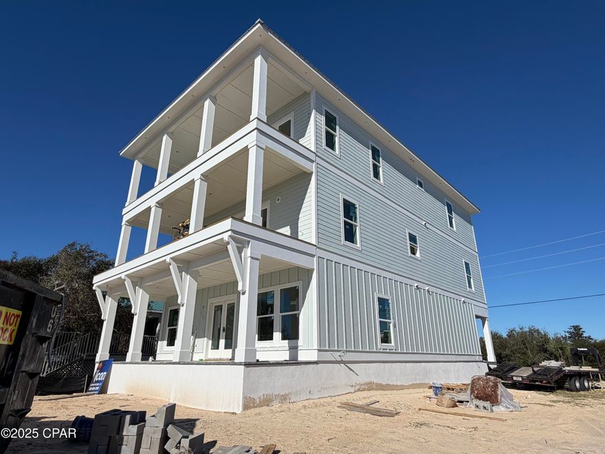 Gulf-facing new construction currently in progress on the dedicated beaches of Mexico Beach. This three story coastal residence is designed to offer approximately 4,500 square feet of heated and cooled living space with panoramic Gulf views from multiple levels. The beachfront directly across from the property is owned by the City of Mexico Beach and permanently dedicated as undevelopable preserving open shoreline and long term view corridors. The thoughtfully designed floor plan accommodates luxury living and large groups with eight bedrooms and eight full bathrooms across three levels providing privacy and functional separation of space. The main living level is planned with an open concept kitchen dining and living area that opens to covered Gulf facing porches creating seamless indoor outdoor living ideal for entertaining. Upper and lower levels provide additional sleeping accommodations and living spaces each enhanced by multiple covered porches and balconies that maximize airflow comfort and water views. Interior plans include upgraded finishes such as tiled showers quality flooring selections modern fixtures and coastal inspired design elements. A private pool and hot tub are planned to the rear of the residence within a defined courtyard setting offering a secluded outdoor retreat while remaining separate from Gulf view entertaining areas. The ground level is designed for parking storage and building access. Flood insurance is not required. With its Gulf facing views protected sightlines generous bedroom count upgraded finishes and strong outdoor living this property is well suited as a primary residence second home or income producing vacation rental in one of Florida's most desirable coastal communities.