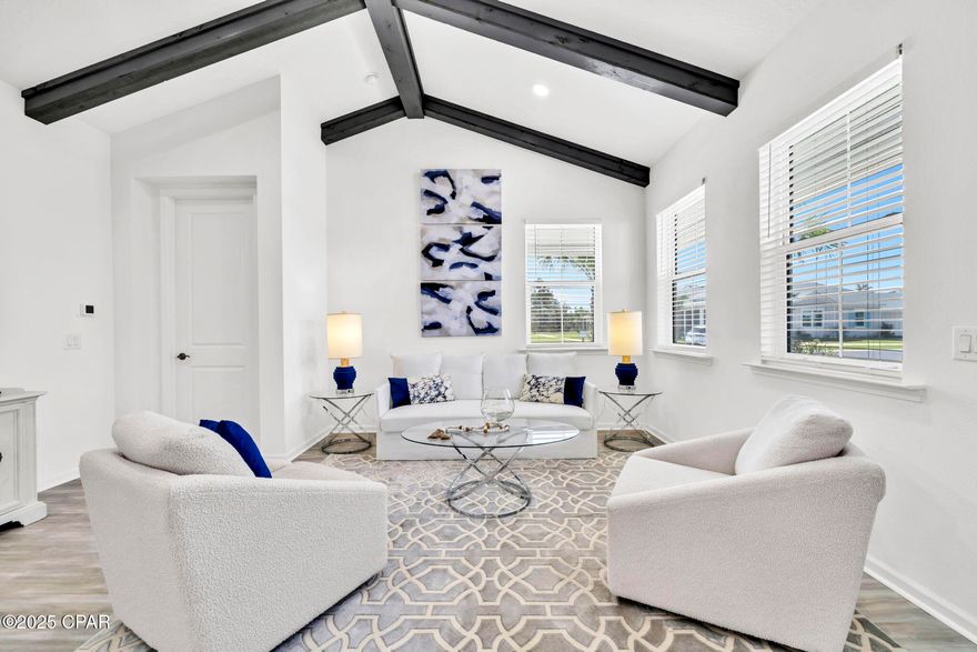 Move right into this street-facing Dreamsicle cottage in Latitude Margaritaville Watersound—where 55+ living feels like a vacation every day. This home showcases thoughtful upgrades, including a waterproof high-performance laminate wood floor throughout for a seamless look, a soaring beamed ceiling, designer lighting, and a custom slipcover sofa. The kitchen boasts quartz countertops upgraded to a rare level five with a matching quartz backsplash—an elegant and valuable enhancement. Both showers feature higher-level tile, and a 75-inch TV conveys for added convenience. The spacious wraparound porch has a cool-seal finish for year-round comfort, and the home's placement provides added breathing room with extra space to the side.
Located in Section 6BC, a highly active part of the community, residents enjoy Friday happy hours, cookouts, and gatherings at the Flip Flop area. Latitude Margaritaville Watersound also offers world-class amenities—resort-style pools, fitness centers, restaurants, live entertainment, pickleball, tennis, and an exciting calendar of social events. This cottage blends stylish upgrades, a desirable location, and a vibrant lifestyle, making it a standout in one of Florida's most sought-after 55+ destinations.