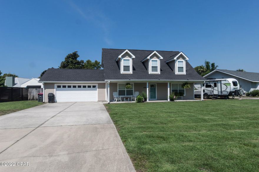 Come see this beautiful Cape style home with solar panels, four bedrooms, two full and one half baths, minutes to the sandy beach and Navy Base NSWC/PC. The  large front porch looks out on the well maintained yard. This home features Hardie board siding, newer roof (2019) and extra detached garage in back. Gorgeous wood look tile flooring in the kitchen, living areas, and baths. The living room has a propane fireplace and is open to Kitchen. Kitchen has granite countertops, subway tile backsplash, solid wood cabinets and stainless appliances. The master suite is on the first floor with an updated master bath, jetted tub/shower combo, and double vanity. Upstairs the full bath has been updated also with wood like tile floors, doubl two have dormers, and one has a walk in closet to die for! Backyard is spacious, has a sprinkler system on a separate shallow well with new pump. Solar lights on the front of the home add striking up lighting at night, and the back porch with the pergola is perfect for that morning cup of coffee! Schedule your showing today, this one won't last long.