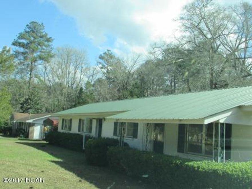 SWMH in Marianna!!  Located on 1 acre is this 2 Bedroom 2 Bath SWMH with 1876 sq. ft. The home has been built around with Concrete Block! Nice manicured lot! City Water & Septic system!  Detached garage. Home to be sold AS-IS.