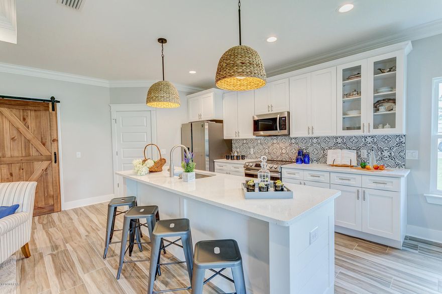 Brand NEW construction! Exquisite, energy efficient home with split floor plan, offering four bedrooms, two baths and gorgeous open concept living. Luxurious features include, double pane windows, tray ceilings, sliding barn door accent, crown molding, wood tile, designer lighting and high-end fixtures throughout. Stunning modern kitchen with beautiful White Carrara quartz counters, white shaker soft close cabinets, attractive tile backsplash and large entertaining island. Kitchen opens out to the dining room and Great room with patio access and lovely shiplap accent wall with fireplace. Optional fourth bedroom can also function as an office. Stylish White Carrara quartz counters and white shaker cabinets in each bathroom. Gather out on the wonderful covered patio with a cool drink. Pristine landscaping with sprinkler system, laundry room, and a spacious two car garage make this home complete! No HOA. Zoning R-1, 3 night minimum stay for rentals.